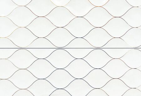 White ceramic tiles in the form of scales. Tile texture with a marine design.