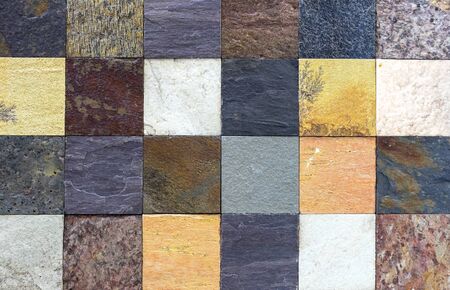 Multi-colored squares from of natural stone for room decor. Blocks made of natural stone. Background of rough stone.の写真素材