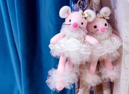 Two pink toy mice in lace white dresses.の写真素材