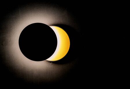 Wall lamp in the shape of a solar eclipse.