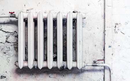 Old cast-iron heating radiator in grunge style.の写真素材