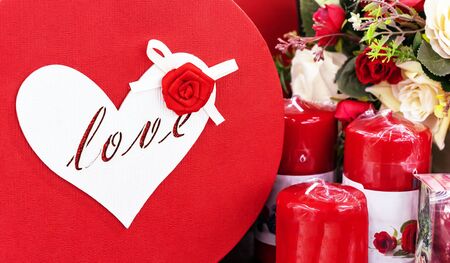 Gift with a heart, flowers and red candles for Valentine's Day.の写真素材