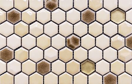 Ceramic mosaic tiles in the form of honeycombs. Hexagonal tiles with cracks.