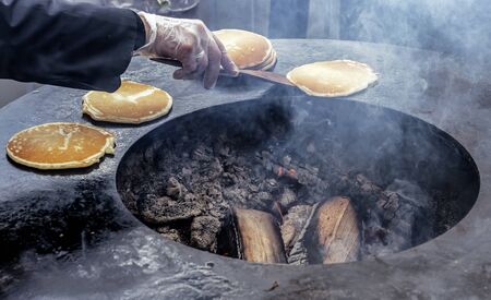 Pancakes are baked in a round stove at the Slavic holiday Maslenitsa.の写真素材