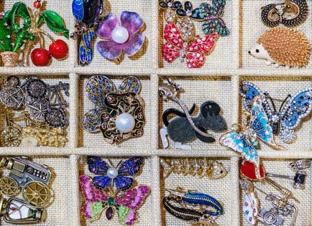 Brooches with pearls and rhinestones in the cells.の写真素材