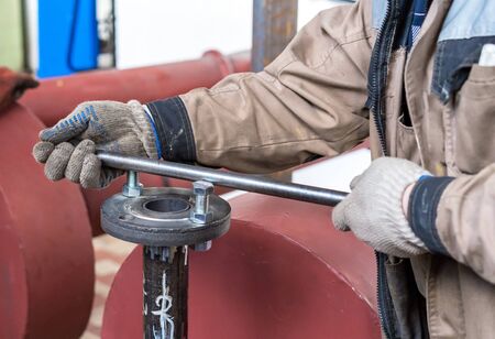 Fitter assembler is assembling a new gas pipeline line in a gas boiler room.