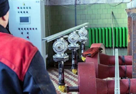 Fitter assembler is assembling a new gas pipeline line in a gas boiler room.