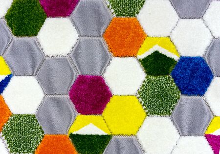 Woolen carpet with a pattern in the form of multi-colored honeycombs.の写真素材