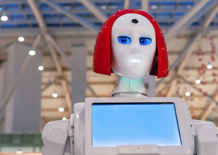 Assistant robot with expressive blue eyes and red hair.の写真素材