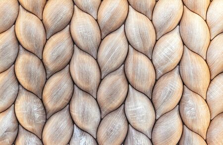 Wooden wall panel with a 3D effect in the form of ears of wheat. Volumetric wooden texture.の写真素材
