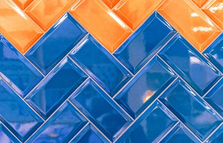 Glossy ceramic tiles with blue and orange rectangles.