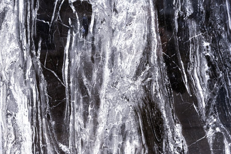 Black quartz stone with white stripes. Natural quartz background and texture.の写真素材