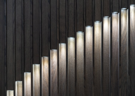 LED spotlights embedded in a decorative wooden panel. Wooden panel with LED lighting.の写真素材