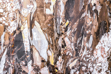 Brown quartz stone with white and yellow stripes. Natural quartz background and texture.の写真素材