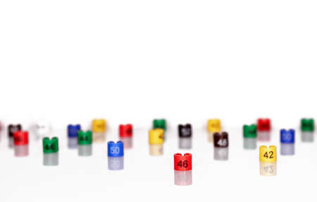Multi-colored plastic size labels for hangers of clothing store on a white background.の写真素材