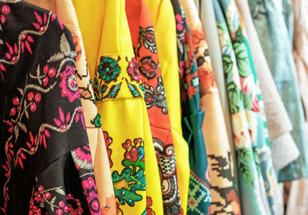 Bright dresses with national Russian ornaments on the store counter.の写真素材