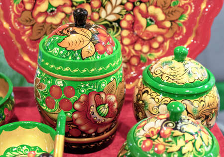 Wooden jar with a lid with a floral ornament in the style of Russian Khokhloma.の写真素材