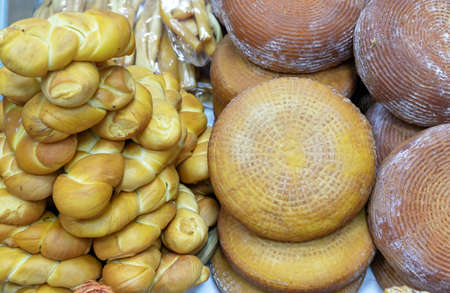 Brown and yellow round cheese and cheese cornrows on the counter magazine.の写真素材