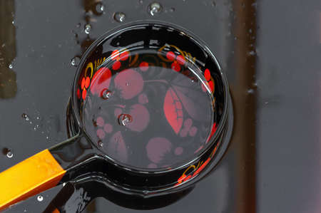 Brown Buckwheat honey in a wooden ladle in the Khokhloma style.の写真素材