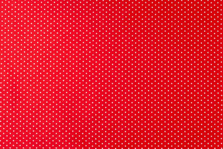 Background of red felt fabric with small white peas.の写真素材