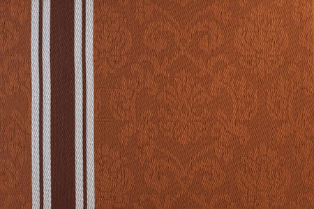 Brown fabric background with a monogram pattern.の写真素材