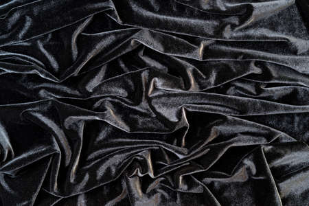 Black velvet background. Crumpled velvet. Velvet with pleats.の写真素材