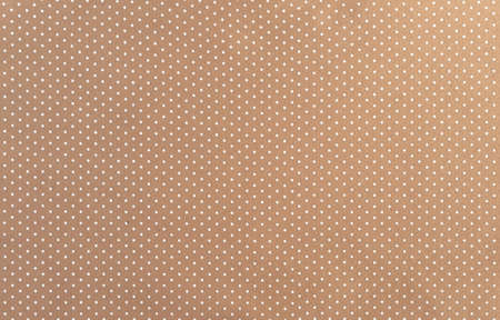 Background of beige felt fabric with small white peas.の写真素材