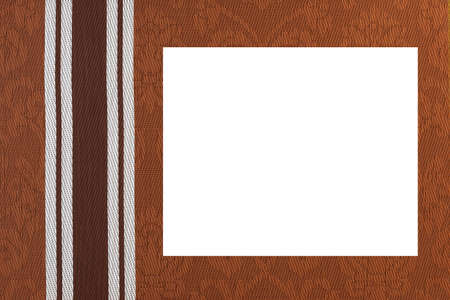 Brown fabric background with monogram pattern and a white middle.の写真素材