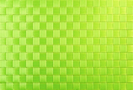 Background from green wicker ribbon. Wicker texture for design and decoration.の写真素材