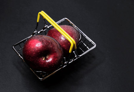Red apples in a supermarket basket. Fruit shopping.の写真素材