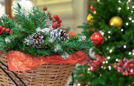 Christmas composition with pine cones, Christmas tree branches and red berries in a wicker basket.の写真素材
