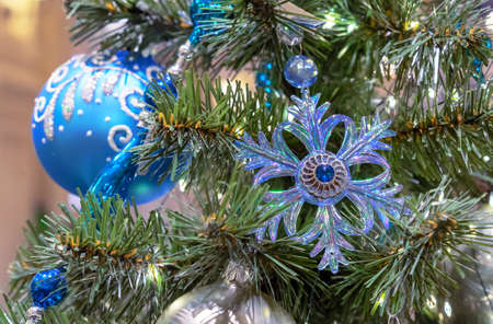 Glass blue snowflake and blue Christmas ball with ornament on the Christmas tree.の写真素材