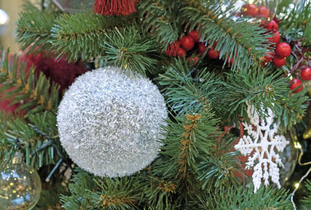 Snow-covered Christmas ball on the Christmas tree. Snowball.の写真素材