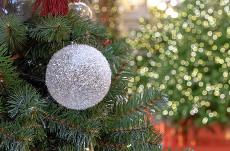 Snow-covered Christmas ball on the Christmas tree. Snowball.の写真素材