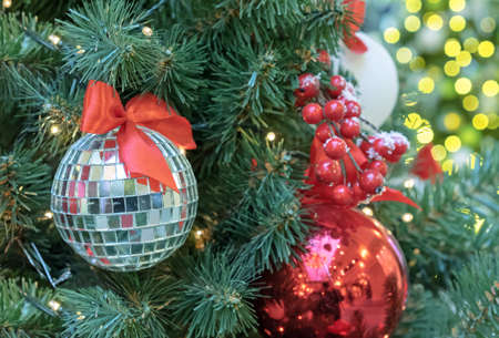 Christmas disco ball with a red bow on the Christmas tree.の写真素材