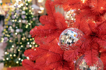Christmas disco ball on a red Christmas tree.の写真素材