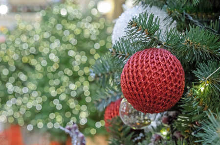 Red shiny Christmas ball with mesh ornament on bokeh background.の写真素材