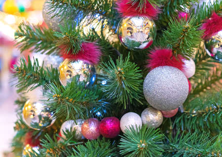 Christmas tree with silver and gold Christmas balls and colorful beads.の写真素材