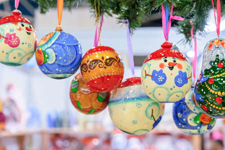 Wooden Christmas balls-snowmen on colorful ribbons.の写真素材