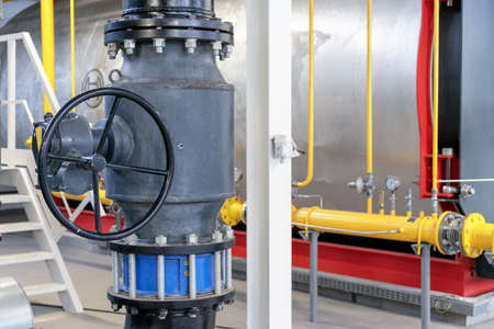 Gate valve with reducer and flanged check valve in a gas boiler room.の写真素材