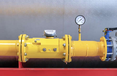 Gas meter and pressure gauge on a gas pipeline in a gas boiler room.の写真素材
