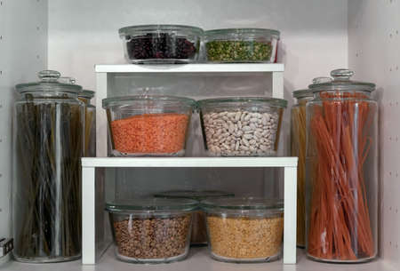 Glass jars with pasta, various cereals and grains. Food storage concept.の写真素材