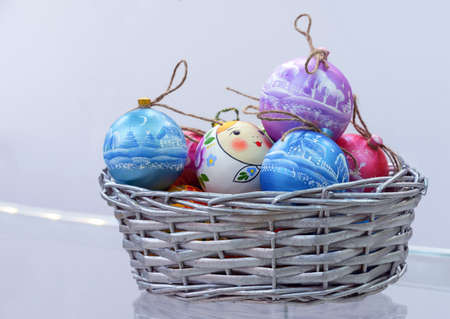 Wooden balls with a winter landscape in a wicker basket.の写真素材