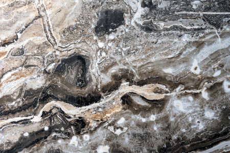 Texture of natural gray-black quartz stone with beige mineral inclusions.の写真素材