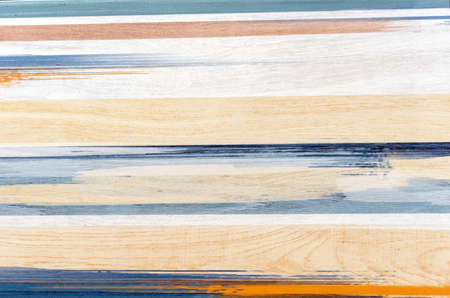 Ceramic tile with blue and beige stripes and wood texture.