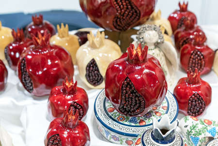 Artificial red pomegranates with crack and grains.の写真素材