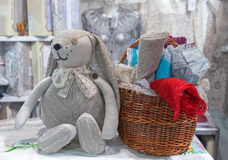 Toy bunny with button eyes and the wicker basket with colorful lace.