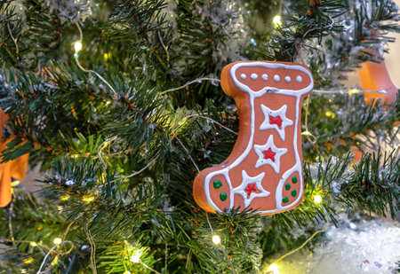 Christmas gingerbread in the form of a boot for gifts on the Christmas tree with a garland.の写真素材