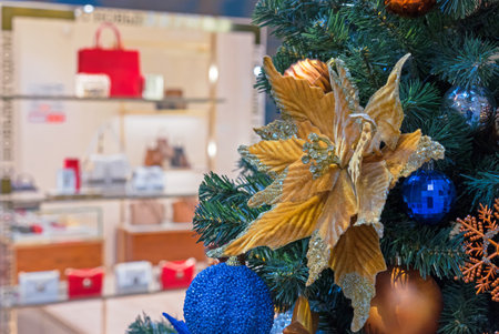 Christmas velvet flower on Christmas tree. Velvet poinsettia with glitter. New Year concept.の写真素材