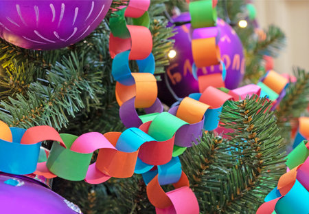 Garland-chain made of colored paper on Christmas tree. Christmas and New Year's decor.の写真素材